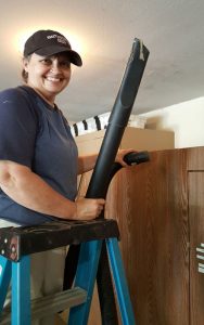 Rhonda Cannady helps to clean and organize the garage